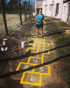 Barclee painting the playground at YWAM St. Lucia